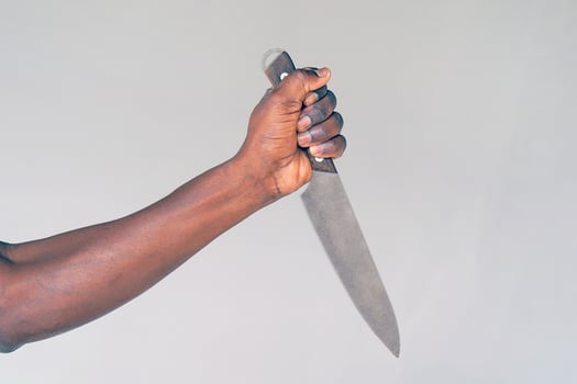 Kitchen knife in a hand black man photo
