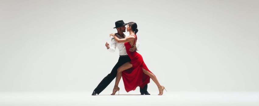 The Dancers Perform a Dramatic Tango Embrace in Elegant Studio Lighting photo