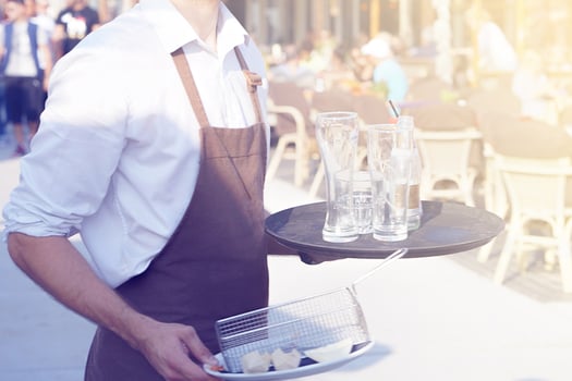 Waiter cleaning the table in a restaurant. photo