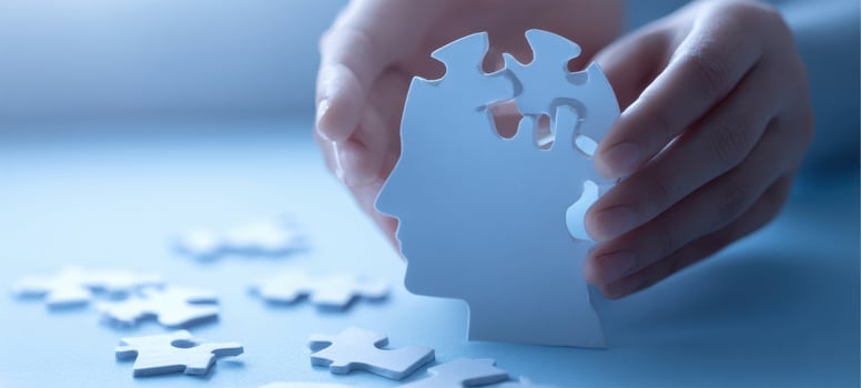 The head-shaped puzzle piece held by hands symbolizing mental health and recovery photo