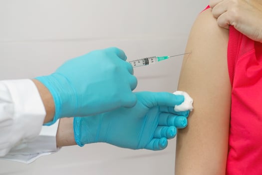 Doctor or nurse hand holding flu, measles vaccine photo