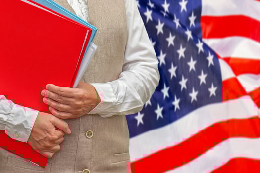 Woman's hands holding documents against US flag background. Education abroad photo