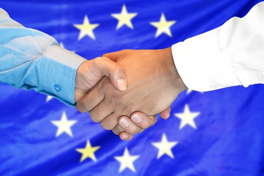 handshake on European Union flag background. photo