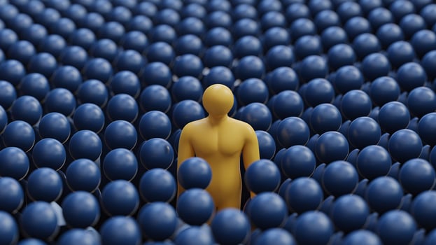 A solitary yellow figure amidst a sea of blue spheres, evoking feelings of isolation and contemplation. photo
