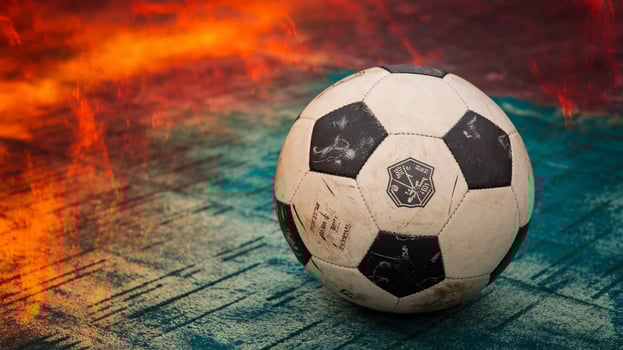 A close-up of a classic black and white soccer ball on a vibrant, textured background. photo