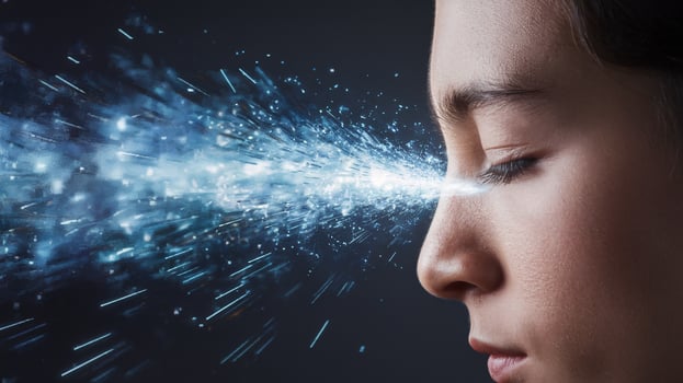 A boy with dark hair closes his eyes, surrounded by a burst of blue light and sparkles, evoking creativity. photo