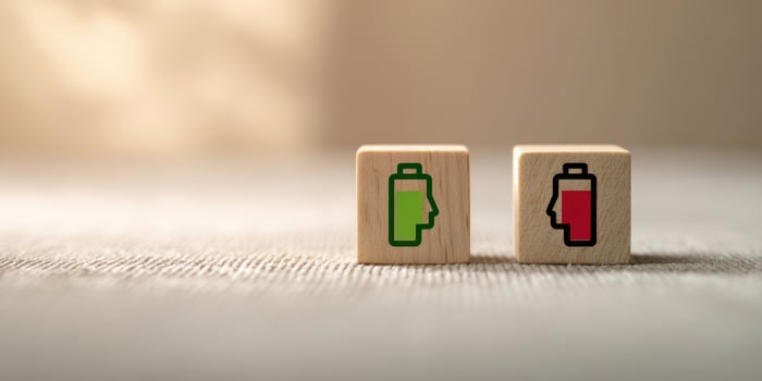 The wooden blocks representing battery levels in contrasting colors for energy awareness. photo