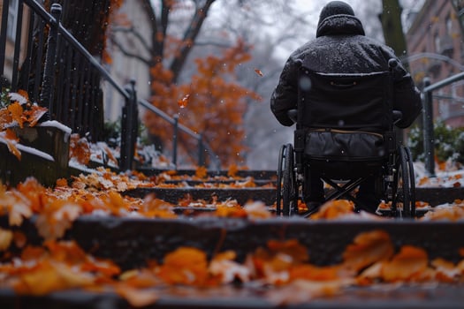 Person in wheelchair navigating autumn leaf covered stairs photo
