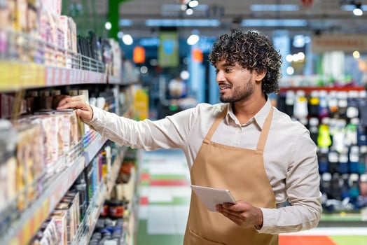 Grocery store employee organizing products photo