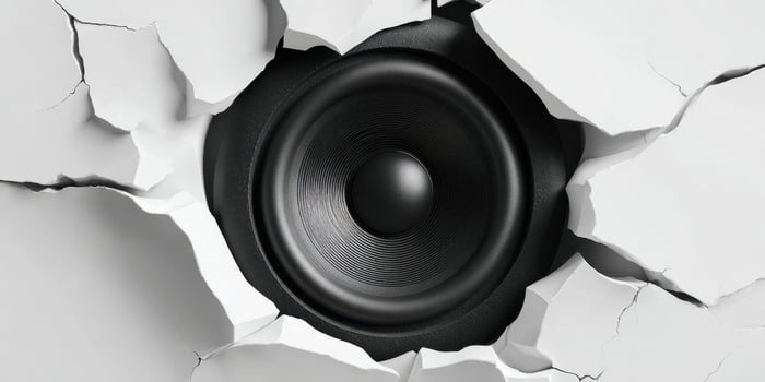 The Cracked Wall Revealing a Powerful Black Speaker Behind It photo