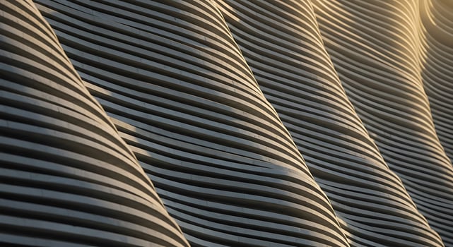 Rhythmic Waves of a Modern Concrete Facade in Warm Golden Light photo