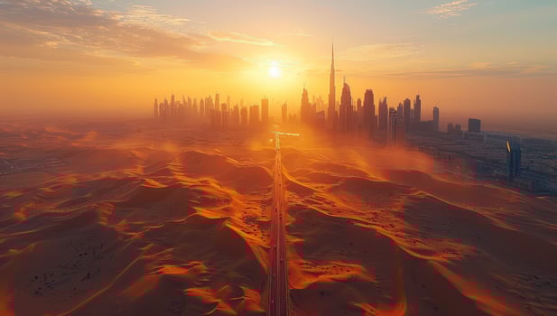 Desert road leading to modern city skyline at sunset scenic aerial view photo