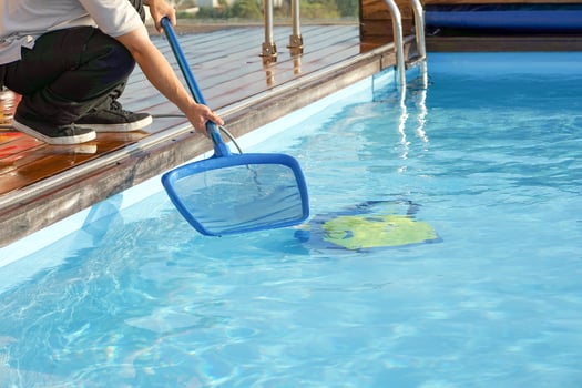 Automatic pool cleaners, man cleaning the pool. photo