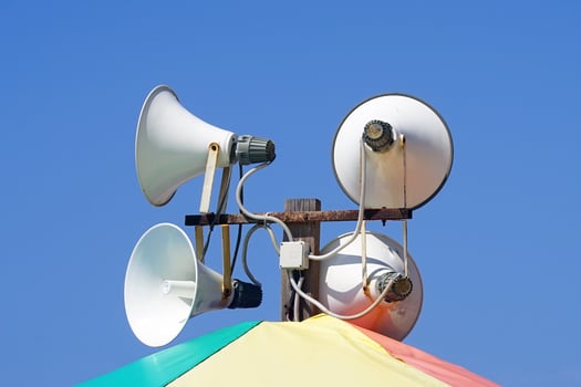 Street alarm loudspeaker on a blu backgrounde photo