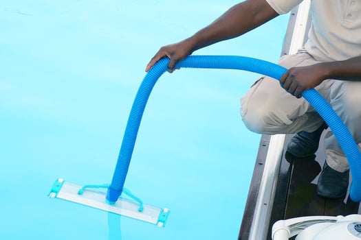 Hotel african employee man with automatic robot in the pool photo