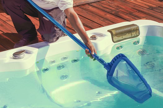 Staff worker cleaning the jacuzzi photo