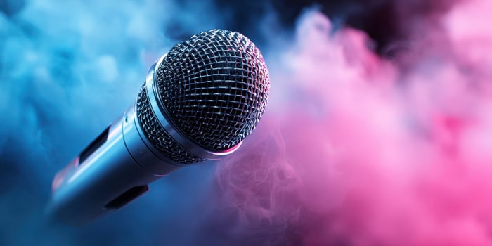 The metallic microphone surrounded by vibrant smoke in a dramatic setting. photo