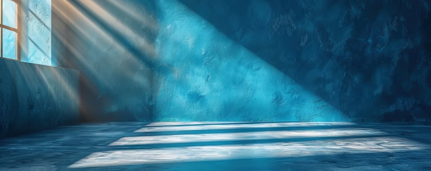 Sunlight streaming through window casting light and shadow on blue textured wall and floor photo