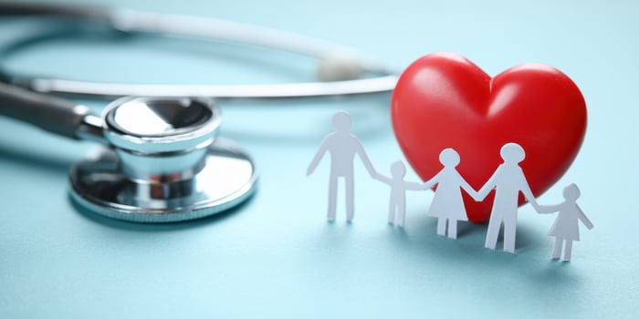 The heart symbolizing family health and care with a stethoscope backdrop. photo
