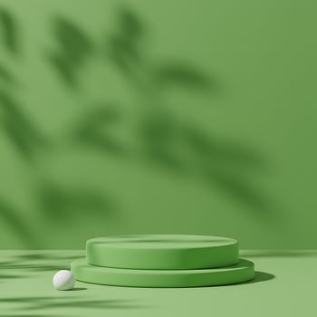 A green table with a white ball on top photo