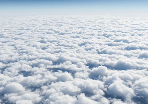 Vast sea of white clouds seen from above, under a clear blue sky photo
