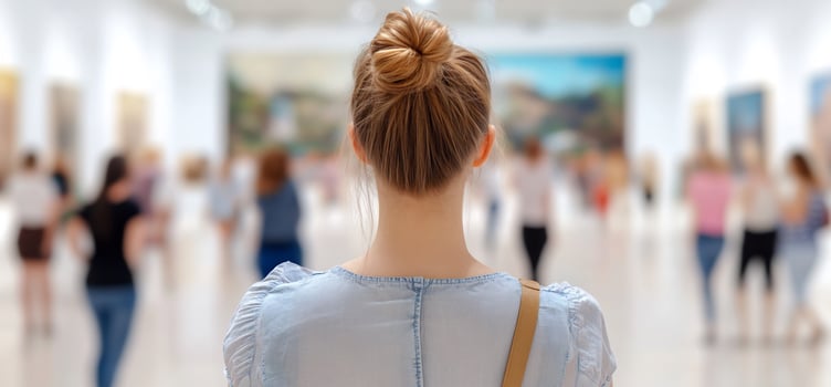 Woman viewing art, gallery, blurred crowd photo
