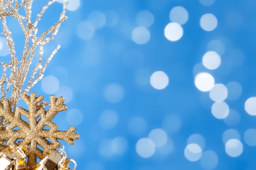 Gold snowflake, bells, winter branches on blue bokeh background holiday card photo