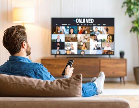 Man watching tv with remote control in living room photo