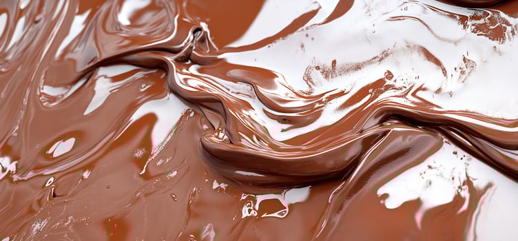 Melted chocolate swirls, closeup texture. Food background photo