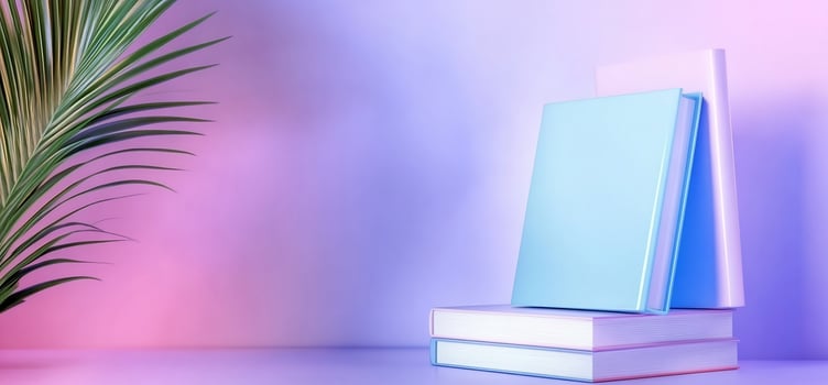 A serene pastel arrangement of stacked books with a palm leaf backdrop photo