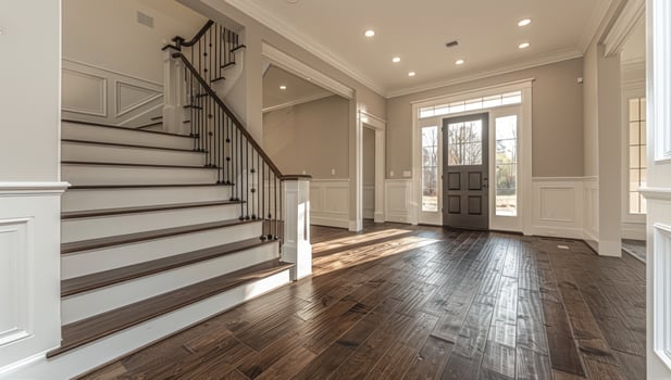 Elegant home interior with staircase and natural light entrance photo