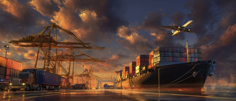 The cargo ship docked at sunset with vibrant skies and busy harbor activity. photo