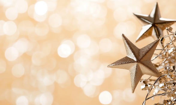 Golden stars and festive decorations against a shimmering background photo