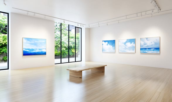 Modern art gallery showcasing serene landscape paintings with natural light photo