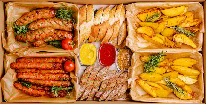 Savoring a delicious meal with assorted sausages, bread, and golden potatoes photo