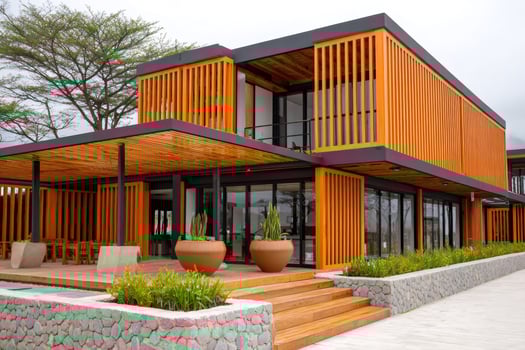 Modern wooden hotel building with orange facade and patio furniture photo