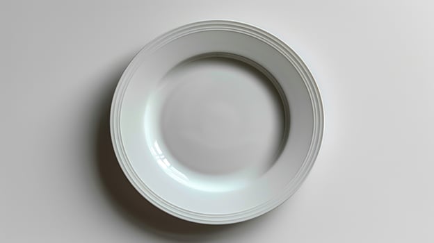 Minimalist overhead shot of an empty white plate for food presentation and menu design photo