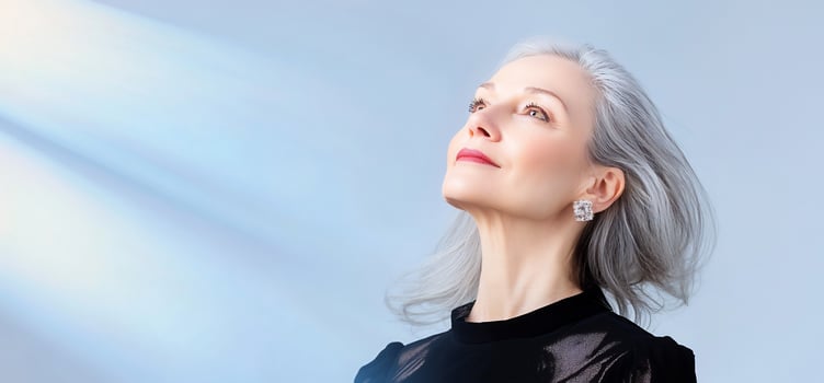 Elegant woman, gray hair, hope, light background, serene photo