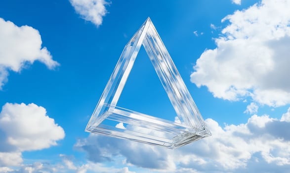 Glass triangle floats in blue sky. Clouds. Design photo