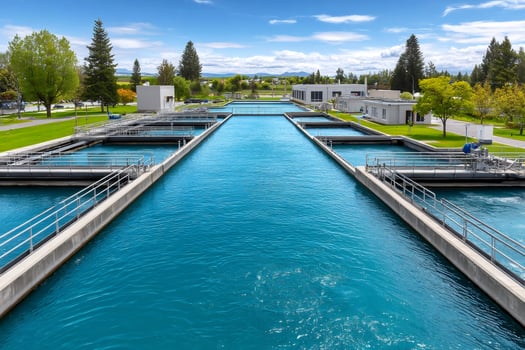 Modern water treatment plant purifying water in tanks on sunny day photo
