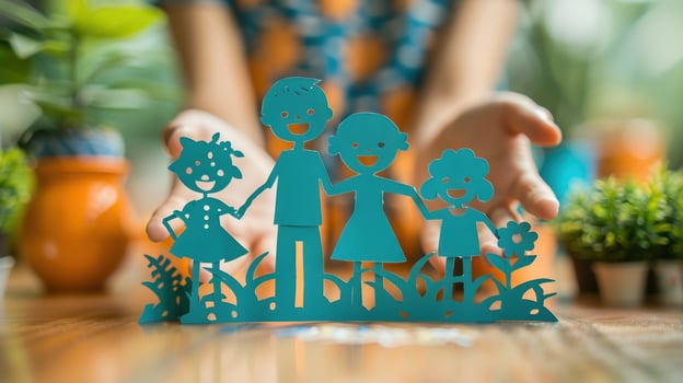 Paper family cutout held in hand concept of togetherness and protection photo