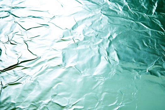 Crumpled teal foil texture background photo
