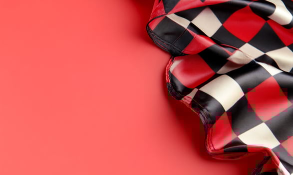 Red background, checkered fabric drape, copy space, design photo