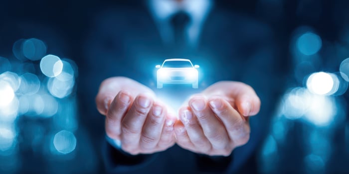 The Hands Holding a Holographic Car Representing Future Automotive Innovation photo