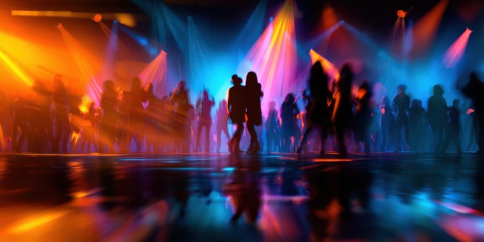 The vivid dance floor illuminated by colorful lights and energetic silhouettes. photo