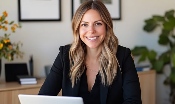 Smiling businesswoman at desk, office background, professional portrait photo