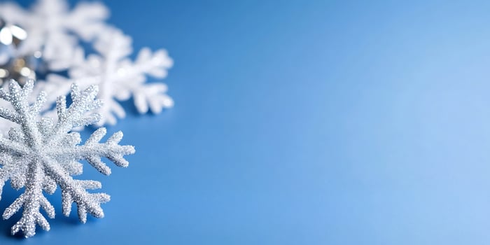 Sparkling snowflakes on blue, winter holiday background photo