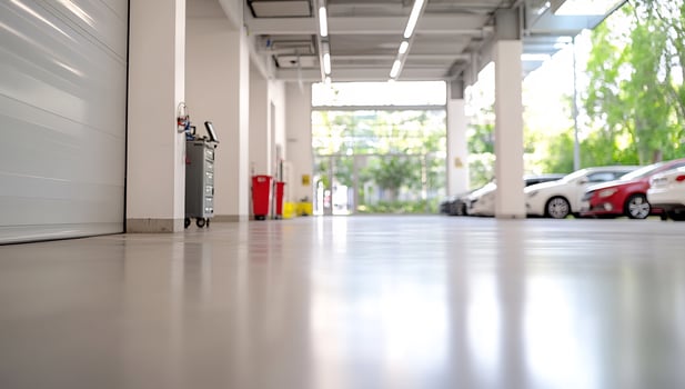 Modern auto service garage interior, parked cars outside, bright sunlight photo