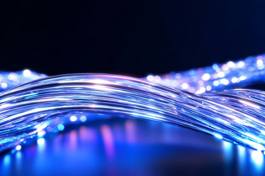 Glowing fiber optic cables curve, dark background, technology concept photo