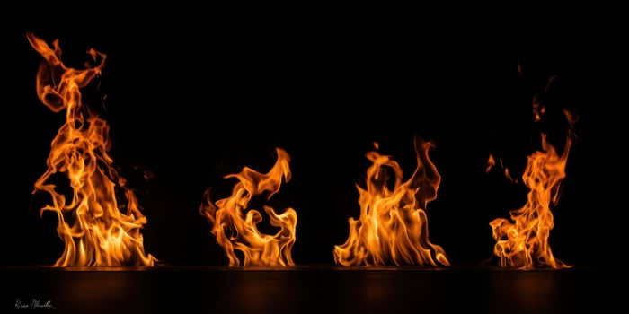 The Flames Dancing Against a Dark Background in a Captivating Display photo